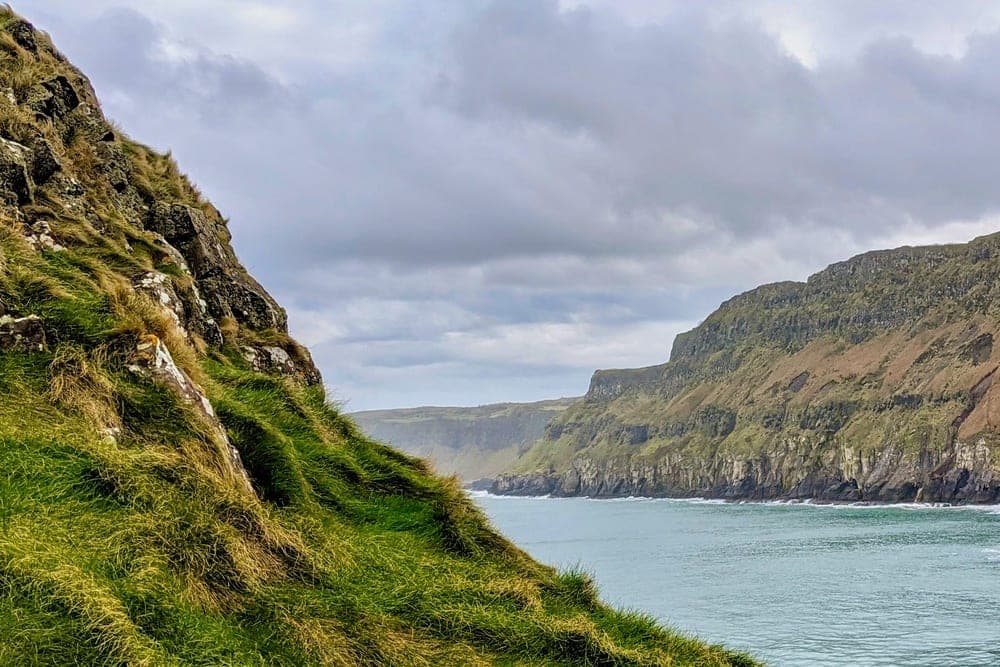 Coastal view of dramatic cliffs and the sea at Whitepark Road, Ballycastle, United Kingdom.