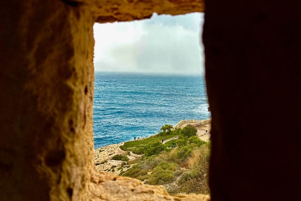 View of the Mediterranean Sea from a stone aperture in Gharsi, Malta.