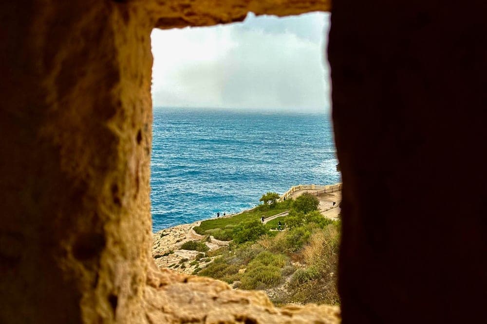 View of the Mediterranean Sea from a stone window in Qrendi, Malta.