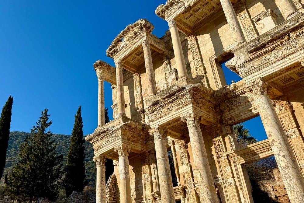 The Library of Celsus in Ephesus, Turkey, under a clear blue sky.