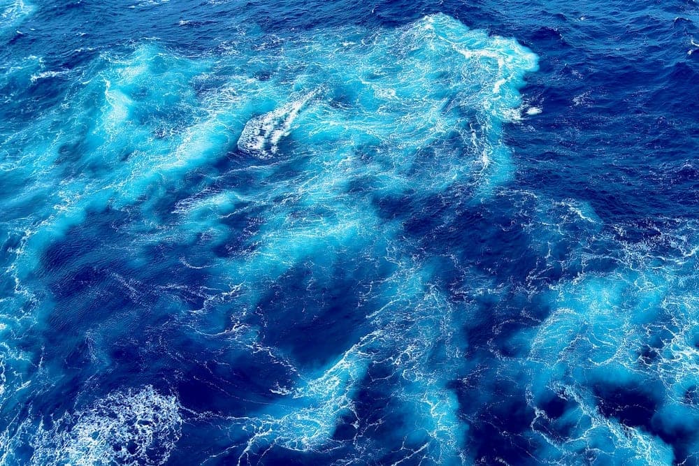 Turbulent blue water of the East China Sea with white foam.