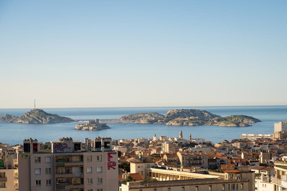 View of Marseille, France, with the Mediterranean Sea and islands in the background, captured on a clear day.