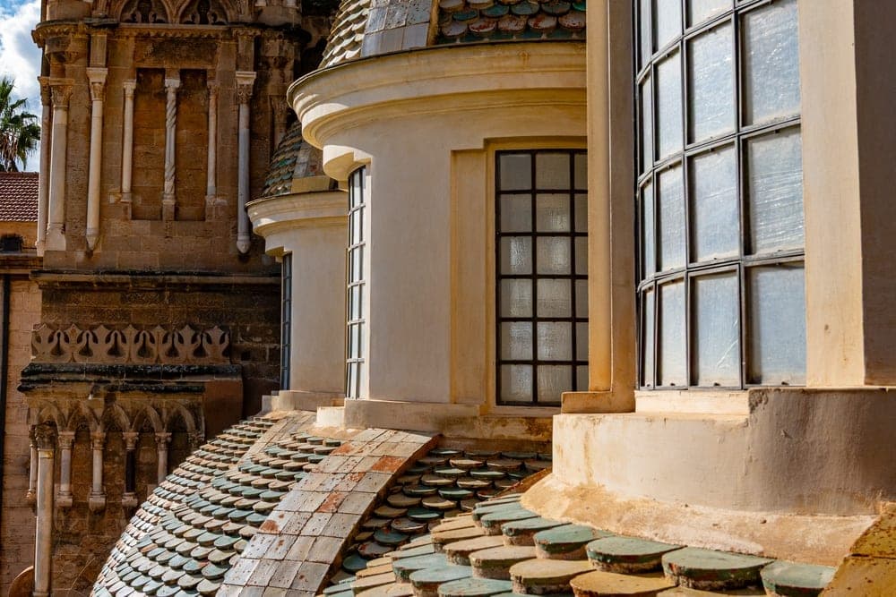 View of historic tiled domes and the bell tower of Palermo Cathedral in Palermo, Italy.