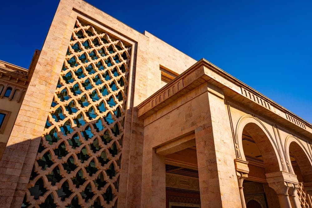 Modern building facade with geometric latticework and arches in Tunis, Tunisia.