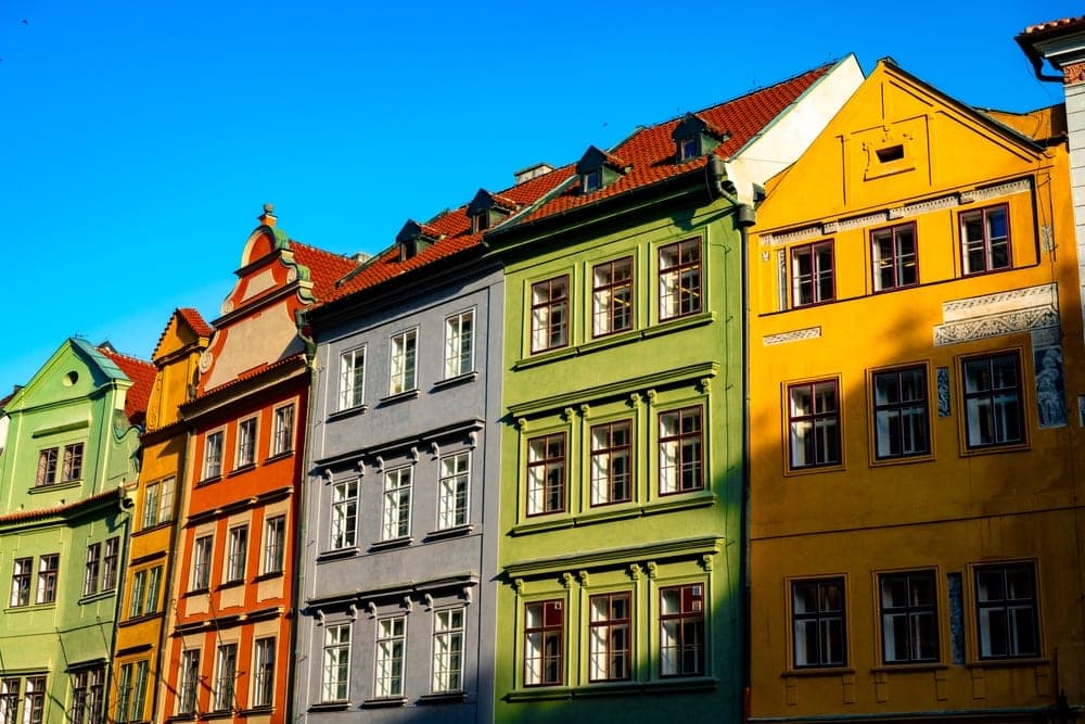 Colourful historic buildings in Staroměstské Náměstí, Prague, Czech Republic, under a clear blue sky.